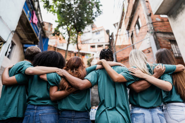 Group of friends standing arm in arm in an urban setting.